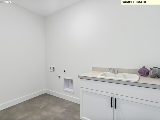 laundry room featuring cabinets, tile flooring, washer hookup, electric dryer hookup, and sink