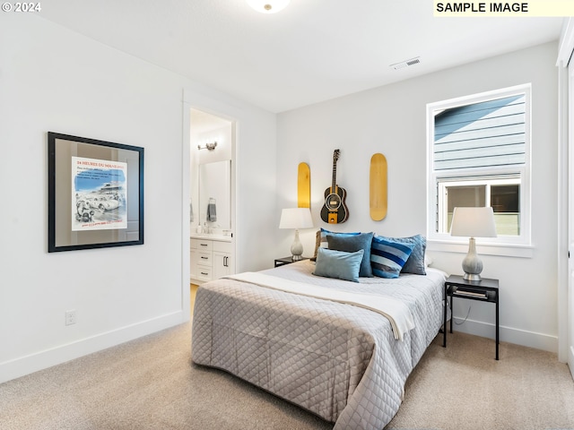 bedroom featuring light carpet and ensuite bath