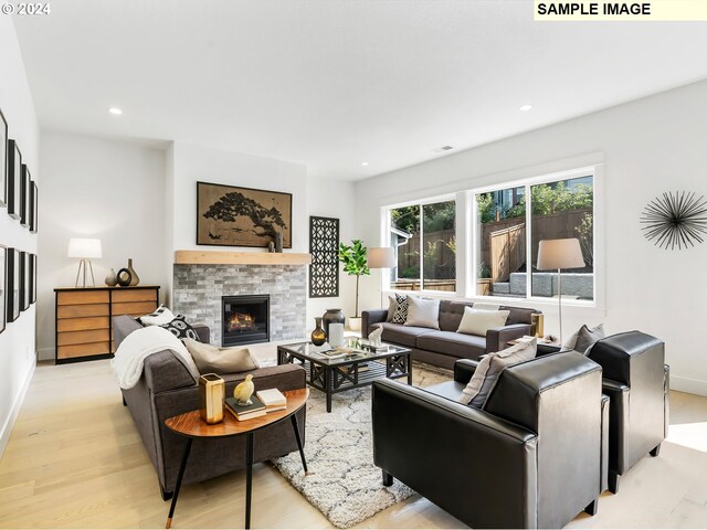 living room featuring light hardwood / wood-style flooring and a fireplace