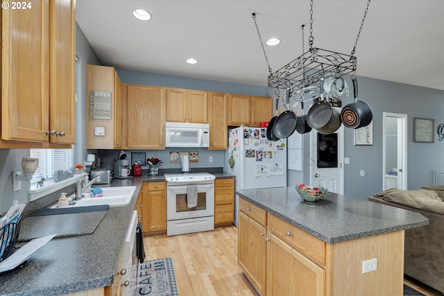 kitchen featuring a center island, white appliances, light hardwood / wood-style flooring, light brown cabinetry, and sink