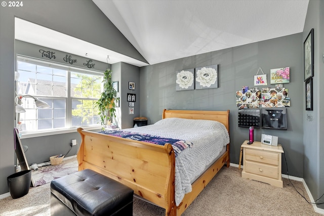 carpeted bedroom with lofted ceiling