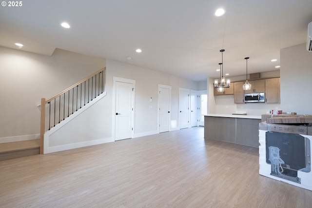 kitchen featuring a notable chandelier, decorative light fixtures, and light hardwood / wood-style floors