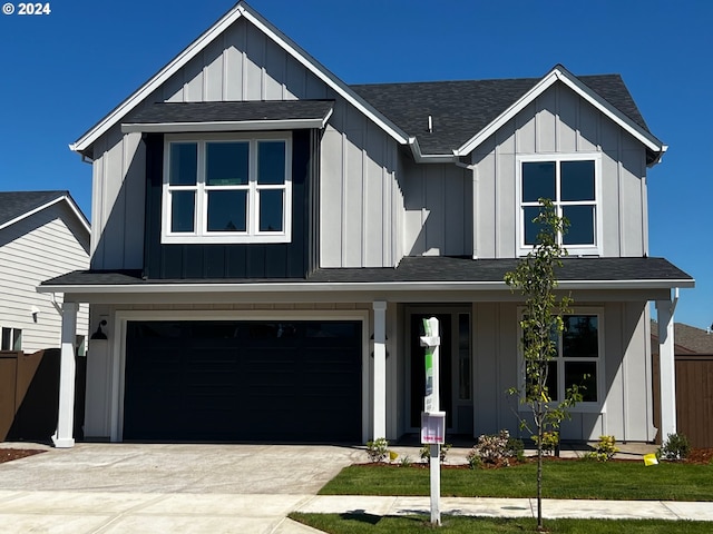 modern farmhouse with a front lawn and a garage