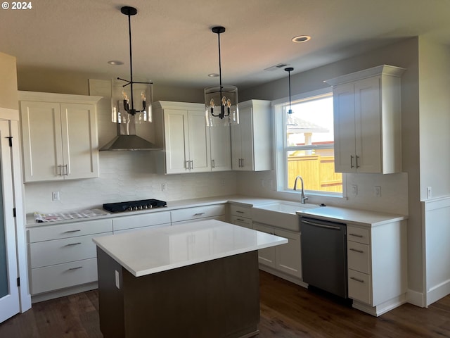 kitchen with a center island, pendant lighting, white cabinets, and stainless steel appliances