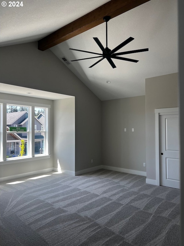 unfurnished bedroom featuring carpet flooring, lofted ceiling with beams, and a textured ceiling