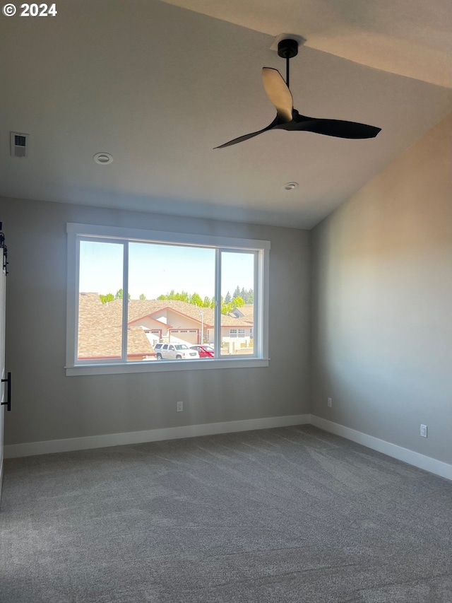 unfurnished room featuring carpet flooring, ceiling fan, and vaulted ceiling