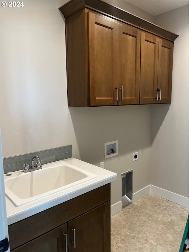 washroom with washer hookup, electric dryer hookup, cabinets, and sink