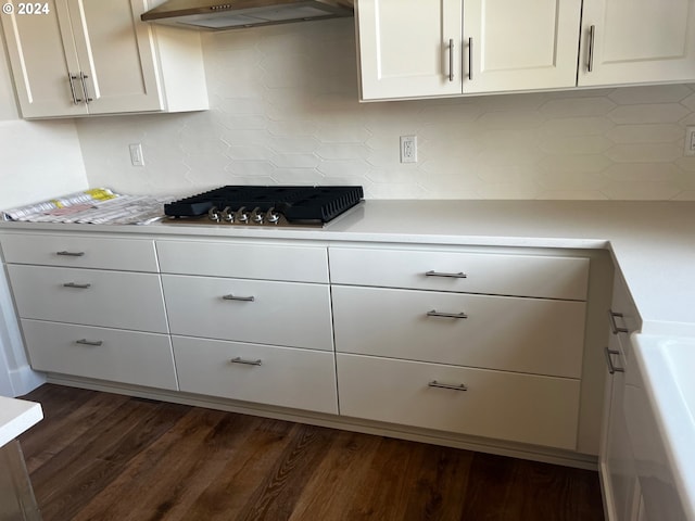 kitchen featuring tasteful backsplash, extractor fan, and dark hardwood / wood-style floors