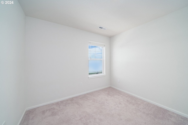 unfurnished room with light colored carpet