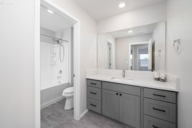 full bathroom featuring toilet, shower / bath combination, vanity, and hardwood / wood-style floors