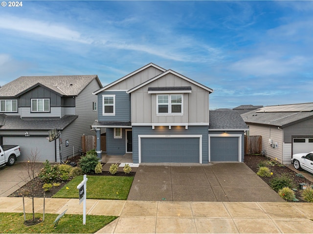 view of front of home featuring a garage and a front yard