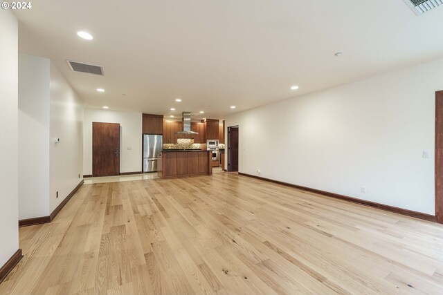 kitchen with dark stone counters, light tile patterned flooring, wine cooler, and appliances with stainless steel finishes