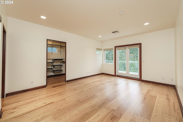 spare room with light hardwood / wood-style floors