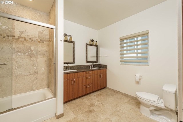 full bathroom featuring shower / bath combination with glass door, toilet, and vanity