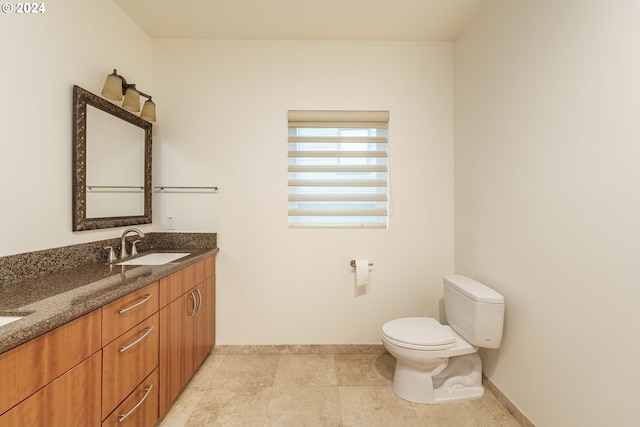 bathroom featuring toilet and vanity