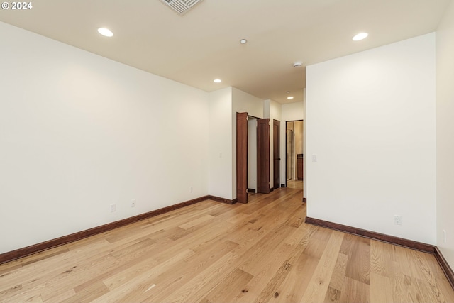 spare room featuring light hardwood / wood-style flooring