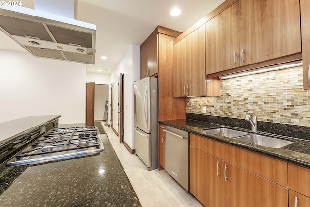 kitchen with sink, range hood, dark stone counters, and appliances with stainless steel finishes