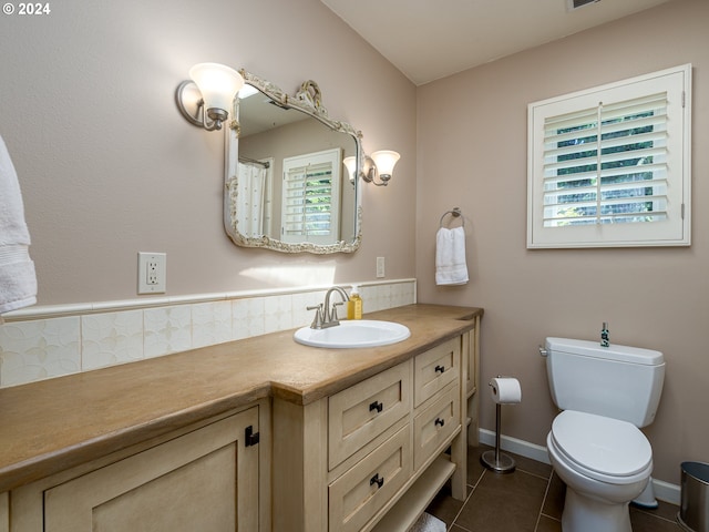 bathroom featuring tile patterned floors, vanity, and toilet