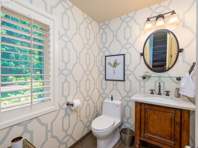 bathroom with vanity, toilet, and tile patterned flooring