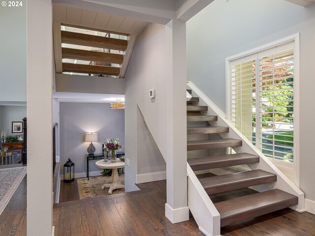 stairs featuring hardwood / wood-style floors