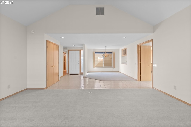 empty room with lofted ceiling and light carpet