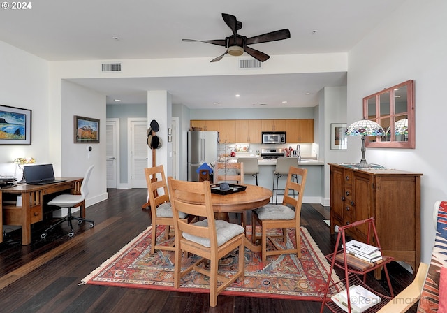 dining space featuring ceiling fan, dark hardwood / wood-style flooring, and sink