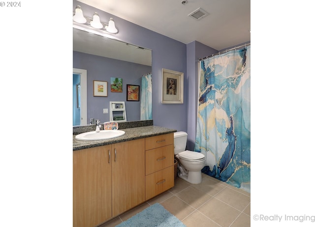 bathroom with vanity, toilet, a shower with shower curtain, and tile patterned floors