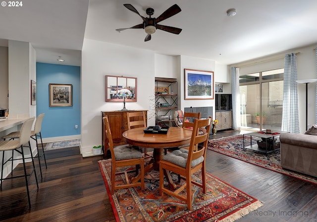 dining space featuring dark hardwood / wood-style flooring and ceiling fan