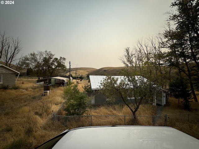 yard at dusk featuring a mountain view