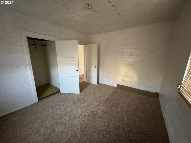 66350 Upper Rock Creek Rd, Arlington, OR 97812 - unfurnished bedroom featuring brick wall, carpet flooring, and a closet