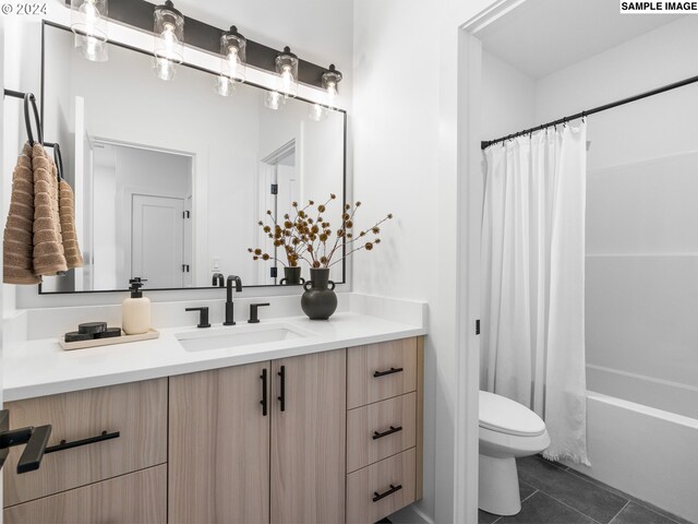 full bathroom featuring toilet, vanity, tile patterned flooring, and shower / bath combo with shower curtain