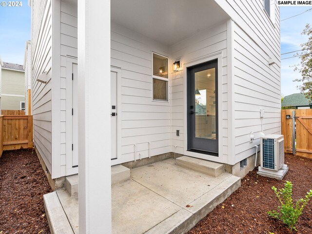 entrance to property featuring a patio area and ac unit