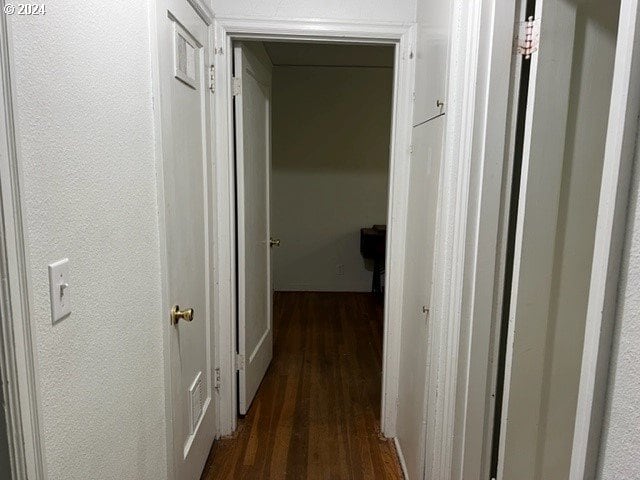 corridor with dark hardwood / wood-style floors