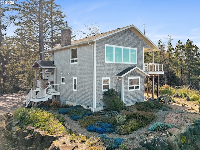 395 Fall Creek Dr, Oceanside, OR 97134 - view of side of home with a chimney and a balcony