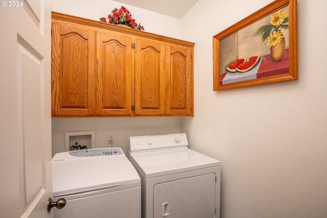 clothes washing area featuring cabinet space and washing machine and clothes dryer