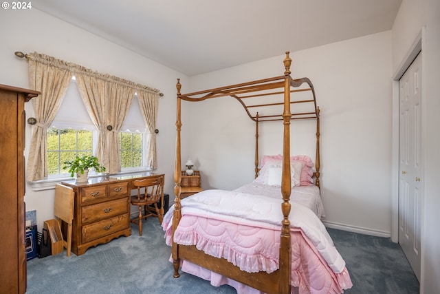 carpeted bedroom featuring a closet and baseboards