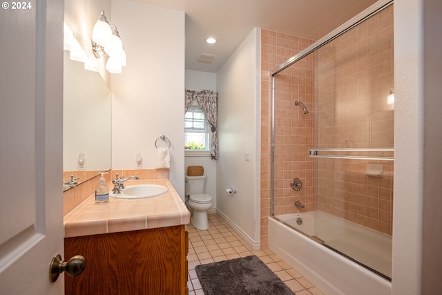 full bath with visible vents, toilet, vanity, shower / tub combination, and tile patterned floors