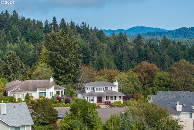 bird's eye view featuring a forest view and a mountain view