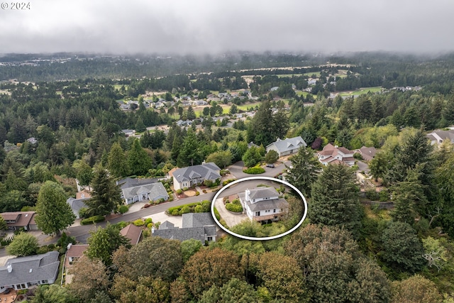 drone / aerial view with a residential view and a view of trees