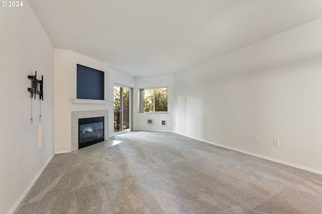 unfurnished living room with a fireplace and light carpet