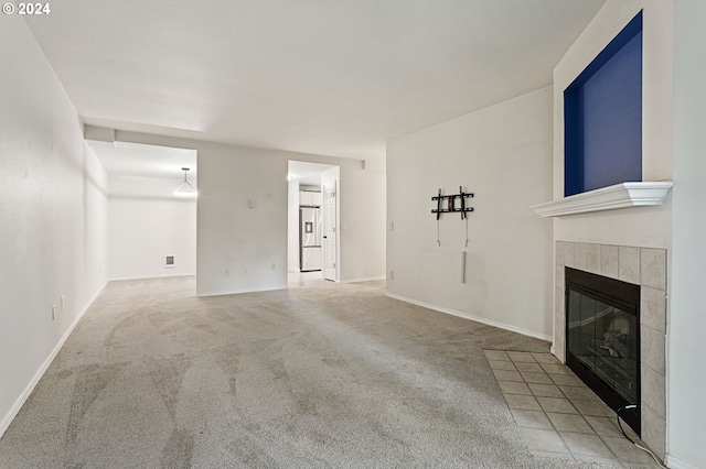 unfurnished living room featuring carpet flooring and a fireplace