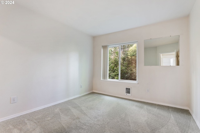 unfurnished room with light carpet