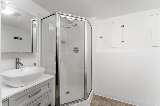 bathroom featuring walk in shower and vanity