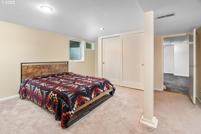 carpeted bedroom with a closet