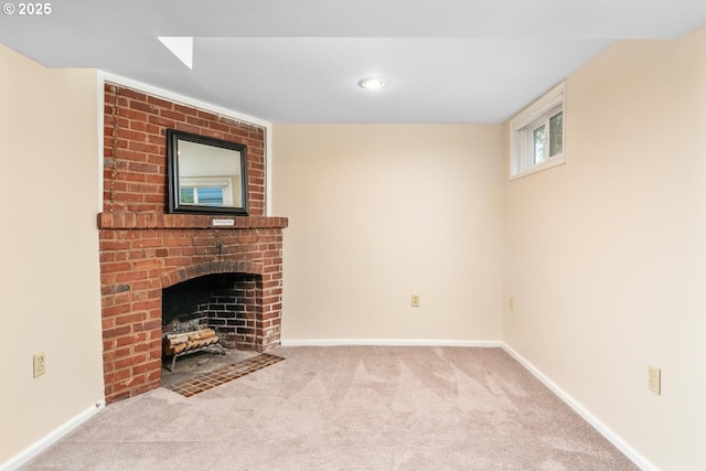 unfurnished living room featuring a brick fireplace and carpet flooring