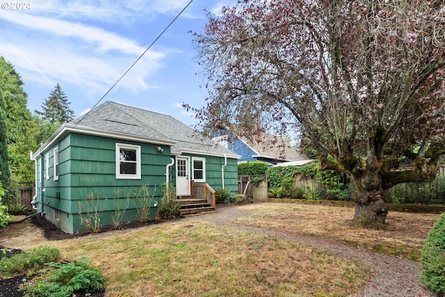 back of property featuring a lawn