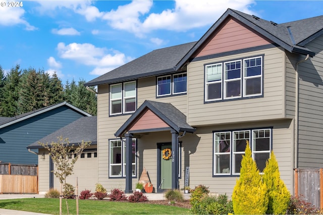 view of front of home with a front yard and a garage