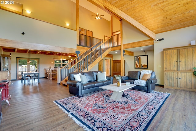 living room with high vaulted ceiling, ceiling fan, beamed ceiling, and hardwood / wood-style floors