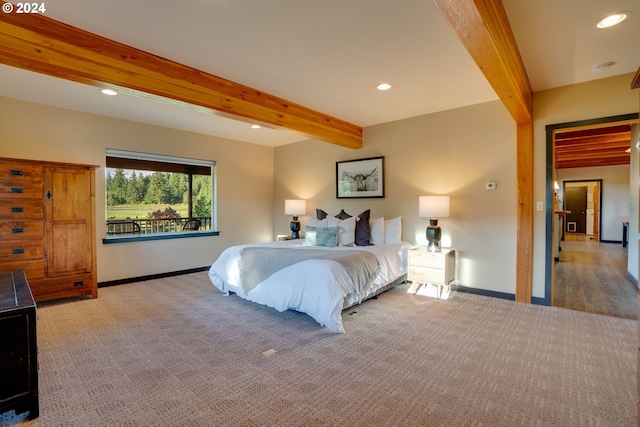 bedroom featuring light carpet and beam ceiling