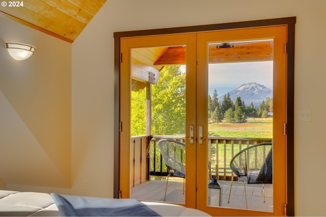 doorway featuring lofted ceiling, a mountain view, wooden ceiling, and french doors